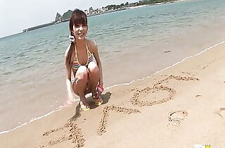 Skinny Chinese lady enjoys having a photoshoot on a beach